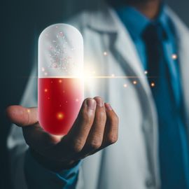 A scientist in a lab coat holding a hologram of a red and blue pill with a model of a molecule, representing AI in pharma. 
