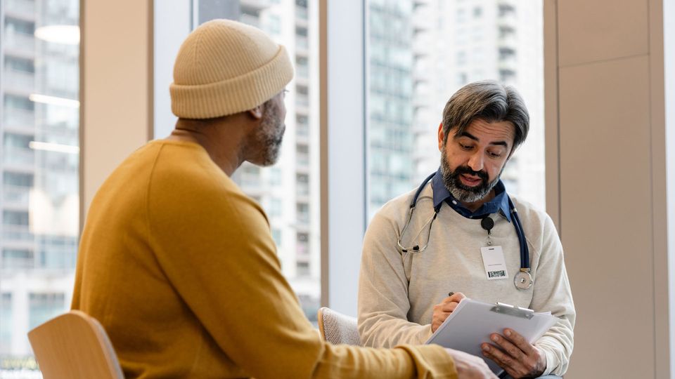 Male patient talking with a doctor.