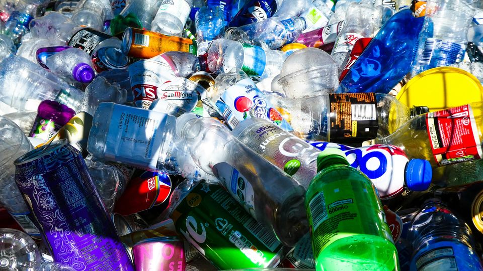 A mixture of waste plastic bottles and cans.