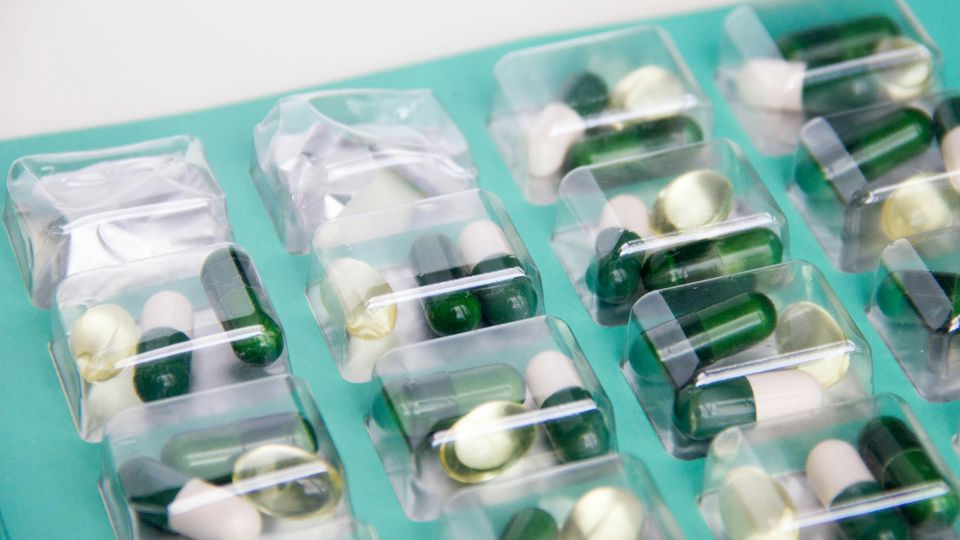 Packets of green and white pills.