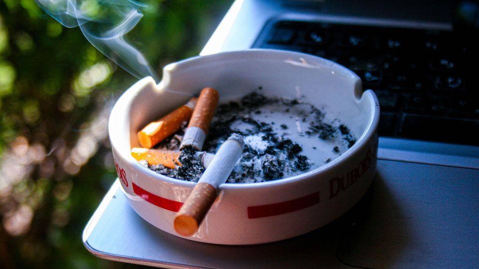 Cigarettes in a cigarette butt dish.