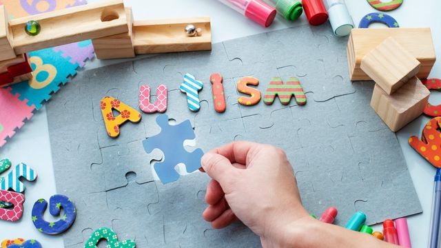 Puzzle with colorful letters spelling autism, symbolizing autism awareness and support. 