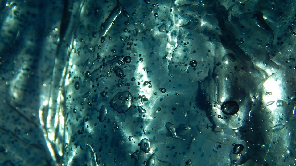 Bubbles trapped in a blue-green slime texture. 