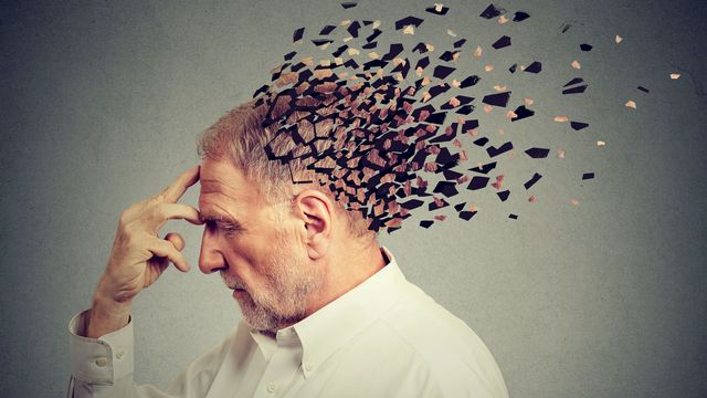 Conceptual illustration of an older man with fragmented head symbolizing memory loss and cognitive decline. 