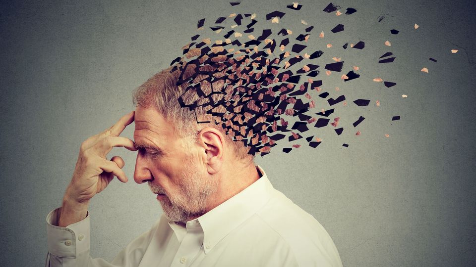 Conceptual illustration of an older man with fragmented head symbolizing memory loss and cognitive decline.