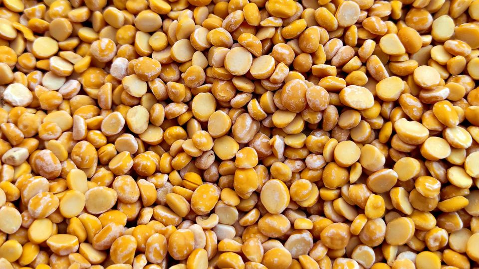 Yellow lentils in a pile.
