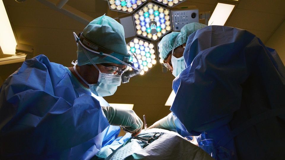 Two surgeons working in an operating theatre