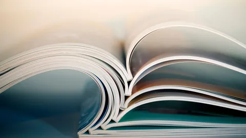 Academic textbooks laid open on a table reflecting academic publishing. 