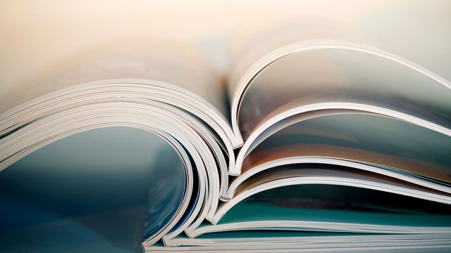 Academic textbooks laid open on a table reflecting academic publishing.  