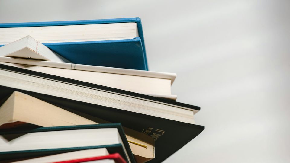 A stack of notebooks against a white background.