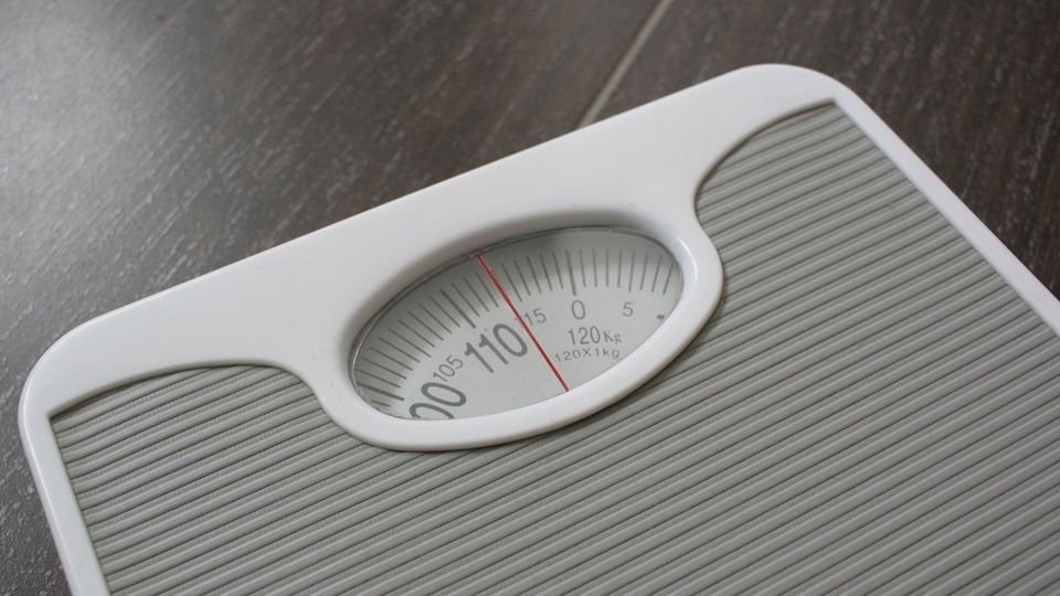 Grey and white bathroom scales.