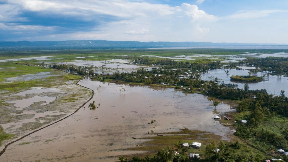 A view of a flood plain in Kenya, flat fields covered in water, sparse treelines less affected.