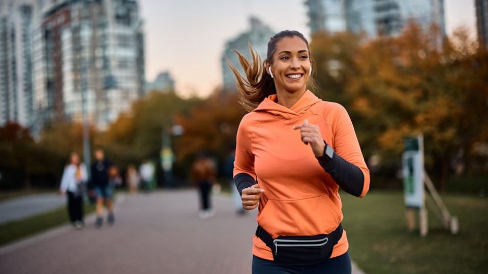 Woman jogging in an urban park, staying active as part of a regular physical activity routine.