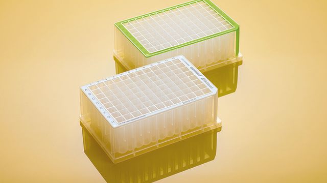 Eppendorf BioBased Deepwell Plates with grid lids shown on a reflective yellow surface. 