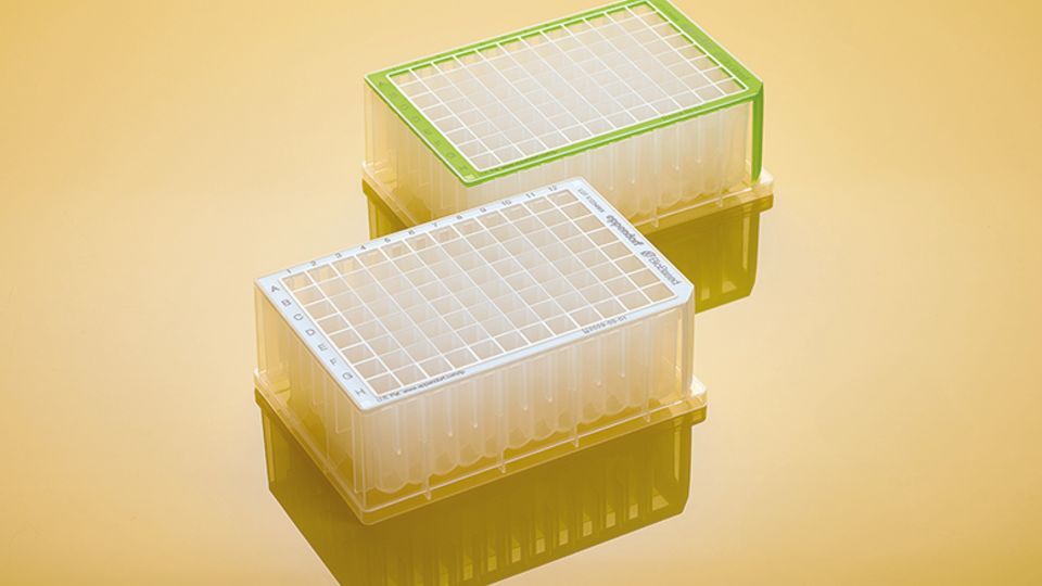 Eppendorf BioBased Deepwell Plates with grid lids shown on a reflective yellow surface.