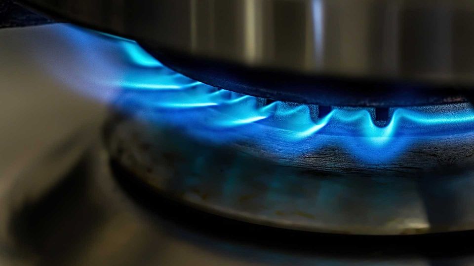 Blue flames from a gas stove representing heat