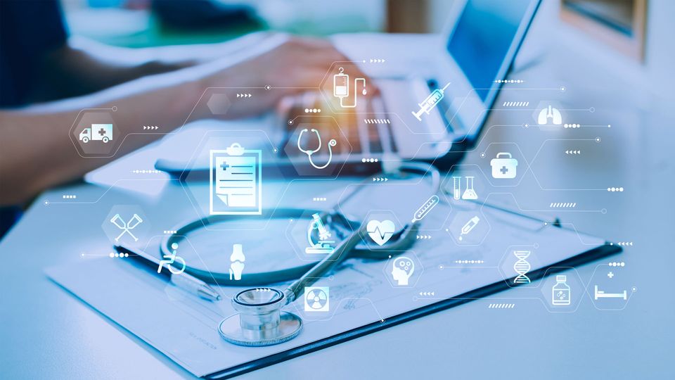 Icons symbolizing health, treatment and diagnosis surround a clinician at a laptop, illustrating the role of AI in medicine.