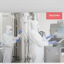 Researchers in cleanroom suits using bioprocess equipment and monitoring systems to seamlessly scale and optimize upstream bioprocesses