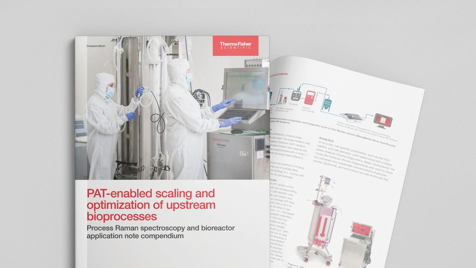 Researchers in cleanroom suits using bioprocess equipment and monitoring systems to seamlessly scale and optimize upstream bioprocesses