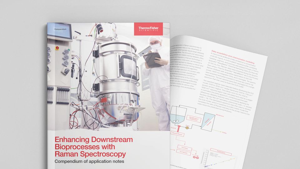 Scientist in protective gear monitoring stainless steel bioprocess equipment to enhance downstream bioprocesses with Raman spectroscopy