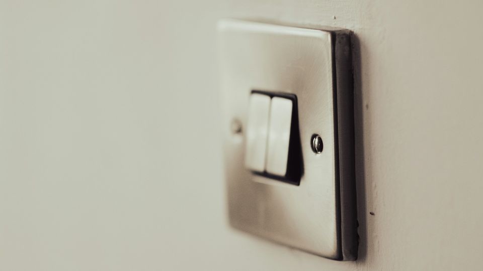 Close-up of a wall light switch symbolizing the concept of an epigenetic switch in gene expression.
