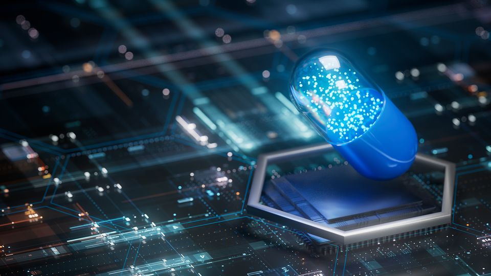A pill on a circuit board illustrating bioinformatics in drug development.