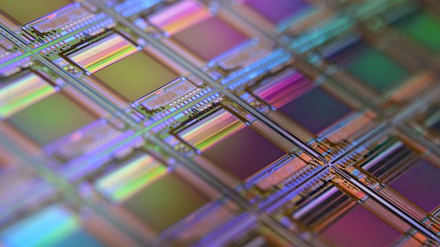 A macro photograph of a patterned silicon wafer, ready for use in electronics.  