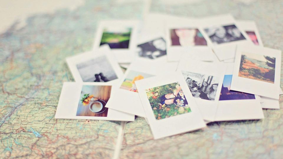 Photographs on a map, symbolizing memory formation.