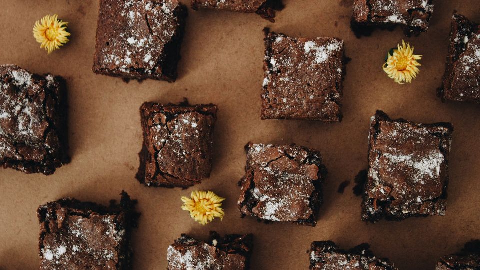 An overhead photo of square brownie slices sat on baking paper.