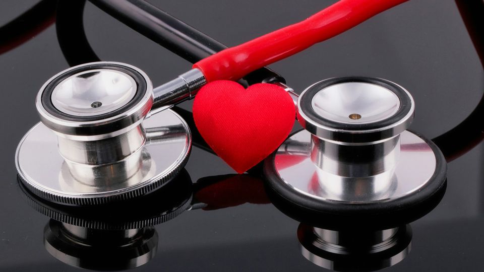 Two stethoscopes framing a red heart symbol, representing coronary artery disease awareness.