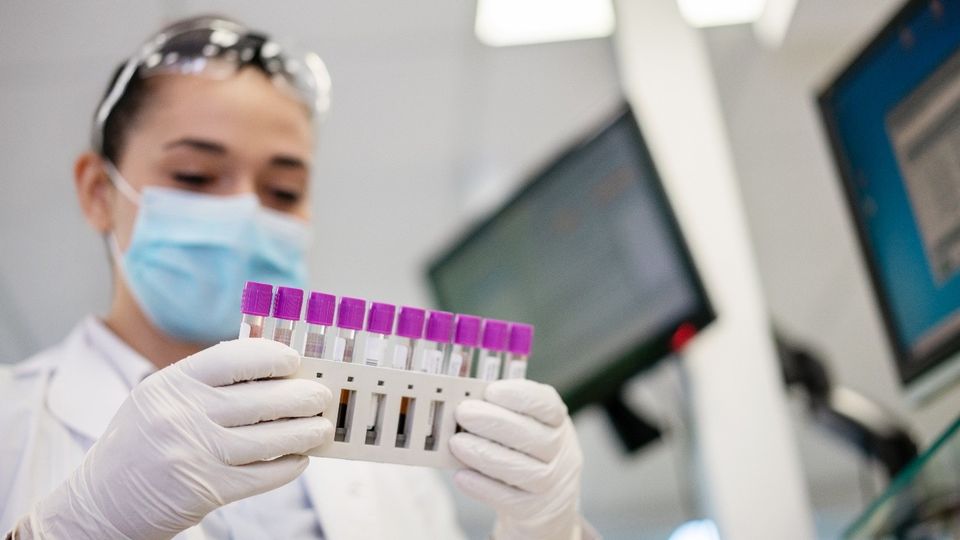 Scientist analyzing test tubes in a lab, representing Nuclera’s eProtein Discovery expansion in the APAC region.