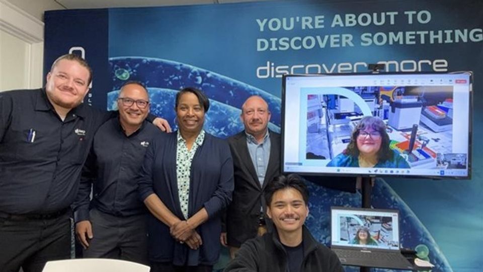 diaago team celebrating ISO 9001:2015 certification in a virtual and in-person meeting.