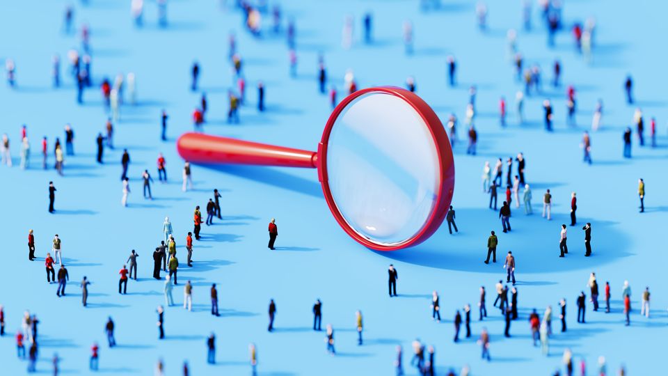 Lots of model people, illustrating population, with a magnifying glass to symbolize analysis.