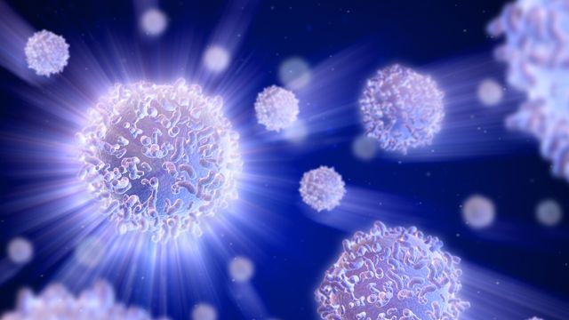 Illustration of white T cells floating on a dark blue background. 