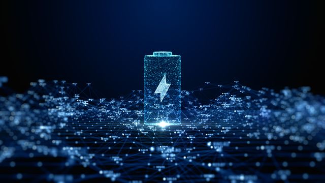 A digital illustration of a battery outline in blue, hovering above a sea of glowing blue dots. 