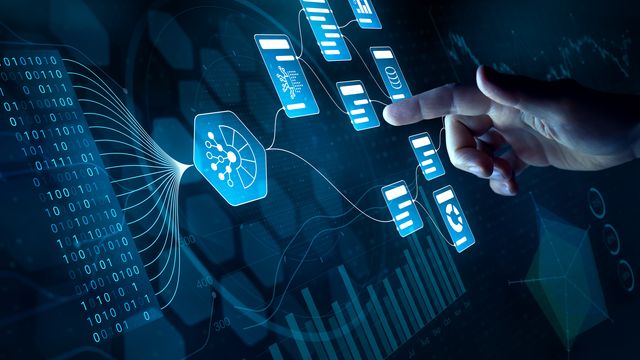 A person using a holographic touchscreen, displaying a flowchart and some binary code. 