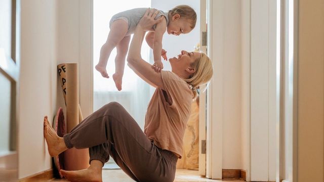 Caregiver holding an infant at home, representing point of care diagnostic testing in everyday settings. 