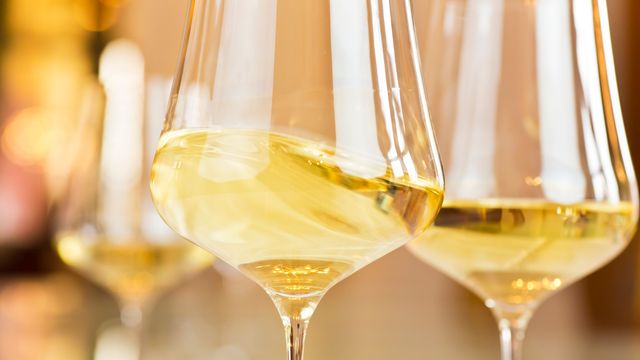 Close up of glasses of white wine. 