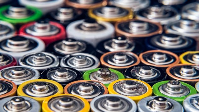 Close-up of multicolored battery cells arranged tightly. 
