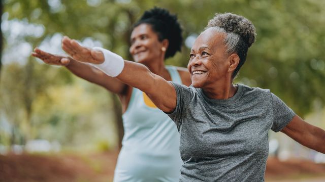 Older women smiling and exercising outdoors, representing active lifestyles of super agers. 