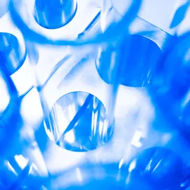 Close up image of test tubes in a tripod on a abstract chemical background.