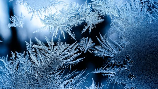 Ice crystals on a transparent glass window. 