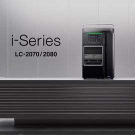 Shimadzu i-Series LC-2070/2080 liquid chromatography system displayed on a sleek lab bench against a modern gray background 
