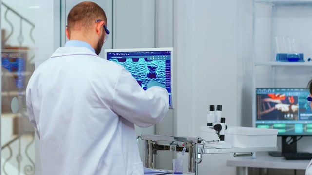 Research scientist reviewing digital analysis in a biotech lab, representing seed funding for early-stage drug discovery. 