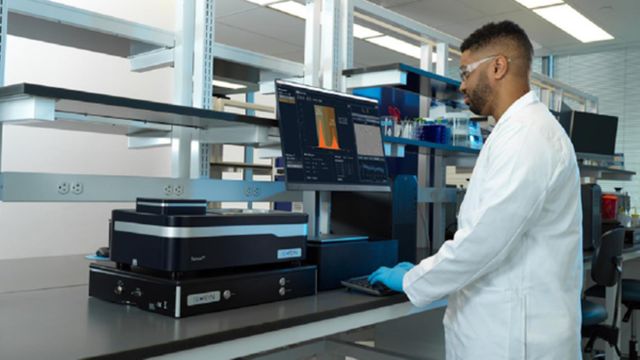 Laboratory scientist operating a mass photometry instrument for label-free biomolecular analysis. 