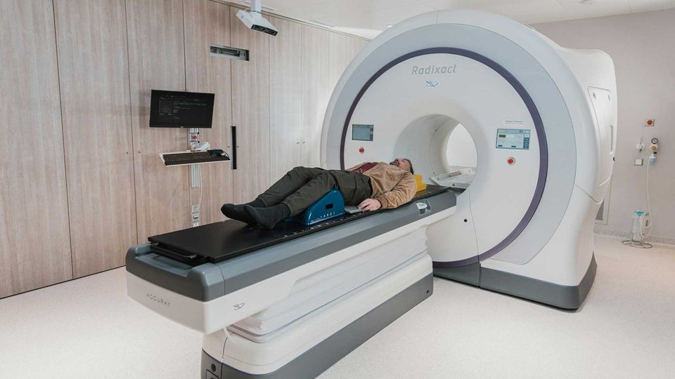 Patient undergoing radiotherapy treatment on a medical linear accelerator machine.