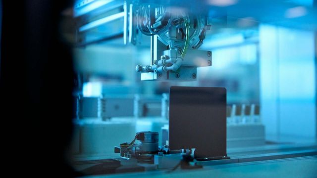 Automated materials analysis system with robotic arm in advanced laboratory setting. 