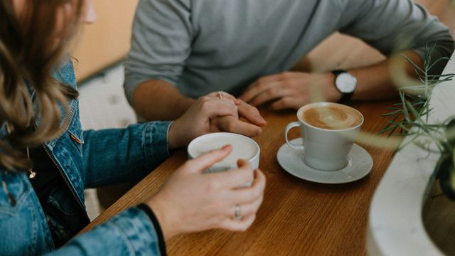 Two people drinking coffee together. 