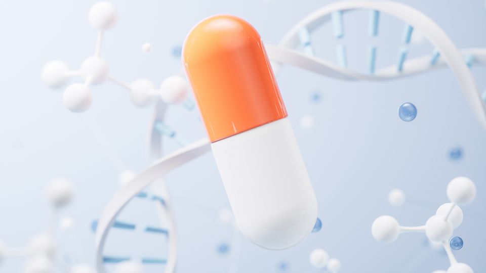 Illustration of an orange and white drug capsule surrounded by a DNA double helix and stick and ball models. 