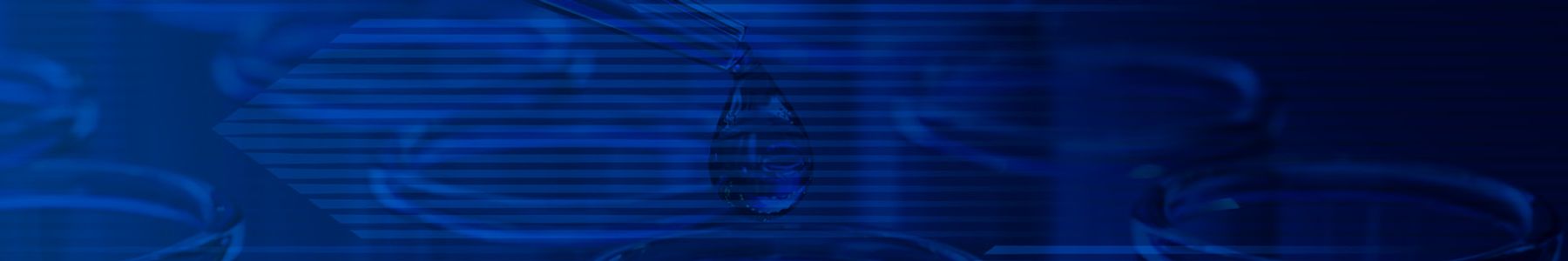 Several blue test tubes in a rack while a pipette drops liquid into one test tube. 